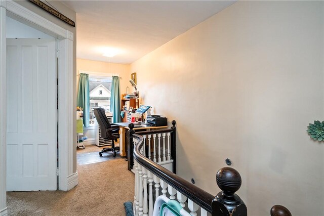 corridor featuring carpet floors and an upstairs landing