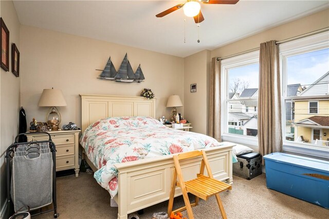bedroom with a ceiling fan and carpet flooring