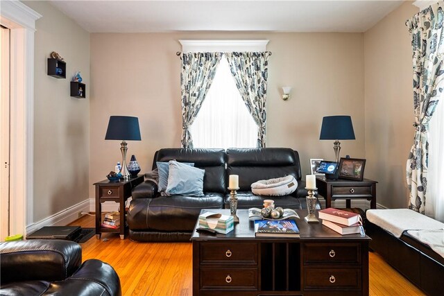 living area with light wood-style floors and baseboards