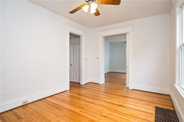 unfurnished bedroom featuring baseboards, light wood-style flooring, and visible vents
