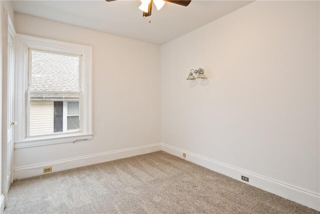 empty room with carpet floors, baseboards, and ceiling fan