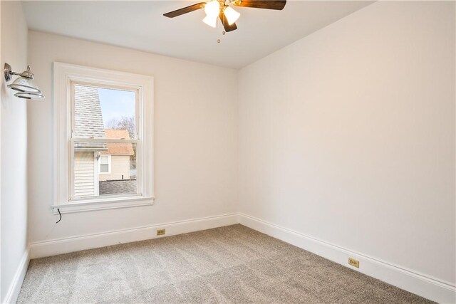 empty room featuring baseboards, carpet, and ceiling fan