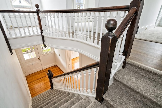 stairs with baseboards and wood finished floors