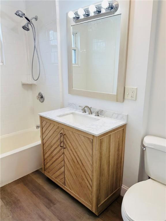 bathroom featuring vanity, wood finished floors, and toilet