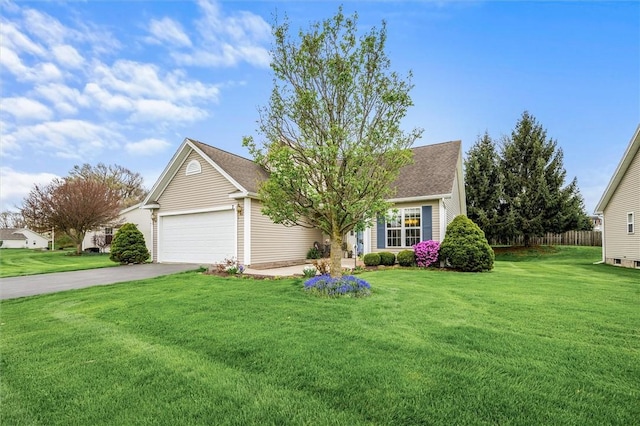 ranch-style house featuring a garage, fence, concrete driveway, and a front yard