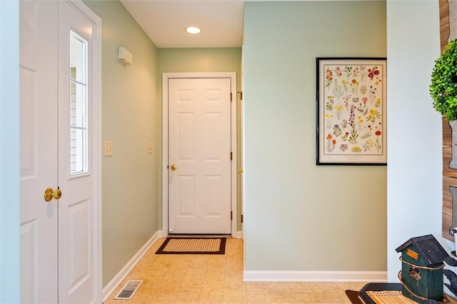 foyer with baseboards, tile patterned floors, and visible vents