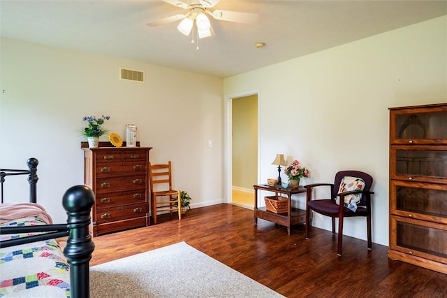 bedroom with ceiling fan, baseboards, visible vents, and wood finished floors