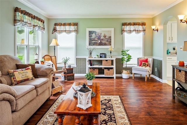 living room with ornamental molding, arched walkways, and wood finished floors