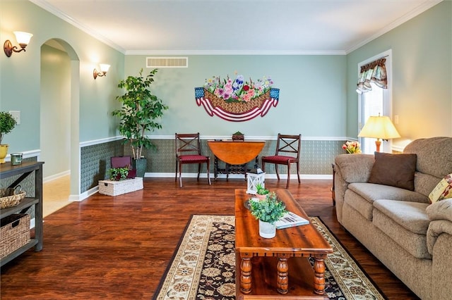 living area featuring arched walkways, ornamental molding, wood finished floors, and visible vents