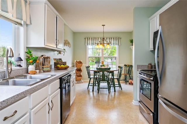 kitchen featuring white cabinets, stainless steel appliances, a sink, and light countertops
