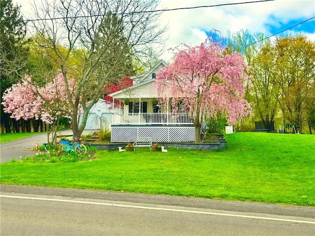view of front of home with a porch and a front yard