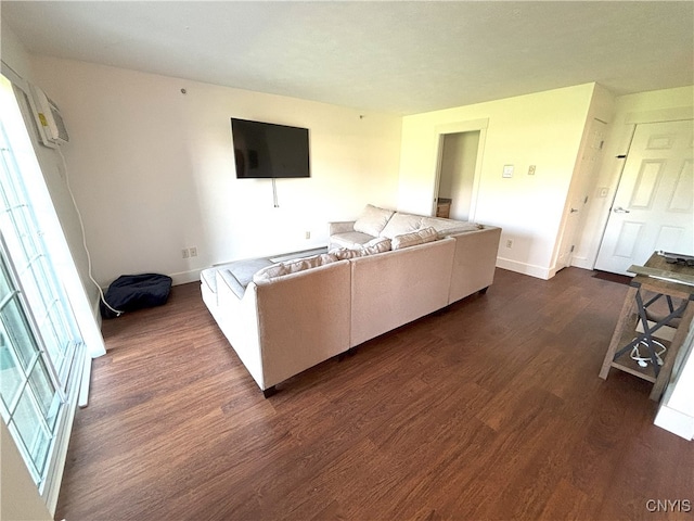 living room with baseboards and dark wood-style floors