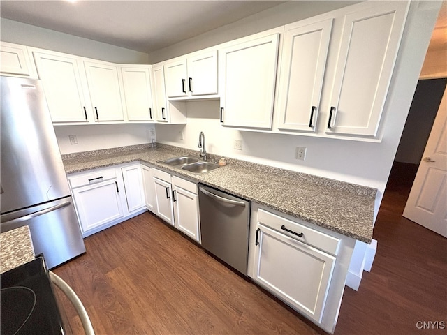kitchen featuring a sink, appliances with stainless steel finishes, dark wood-style floors, and white cabinetry