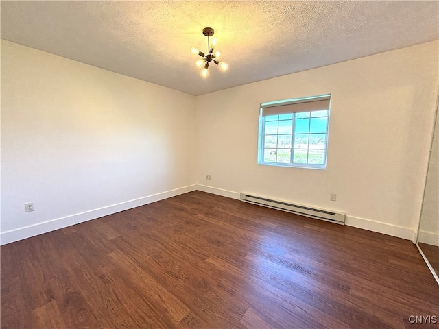 empty room with baseboards, a baseboard heating unit, dark wood-type flooring, and a chandelier