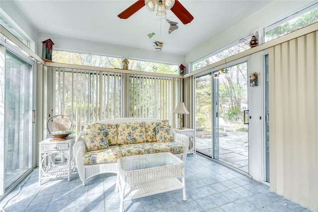 sunroom with crown molding and a ceiling fan