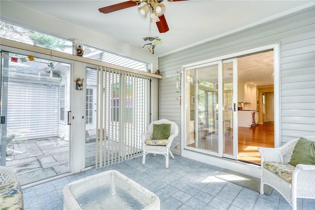 sunroom / solarium featuring ceiling fan and a healthy amount of sunlight