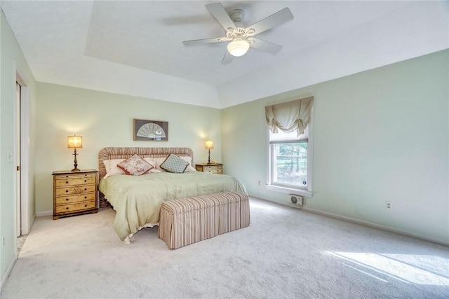 bedroom featuring baseboards, a raised ceiling, carpet, and ceiling fan