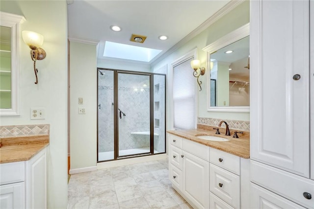 full bath featuring backsplash, a skylight, a shower stall, vanity, and ornamental molding