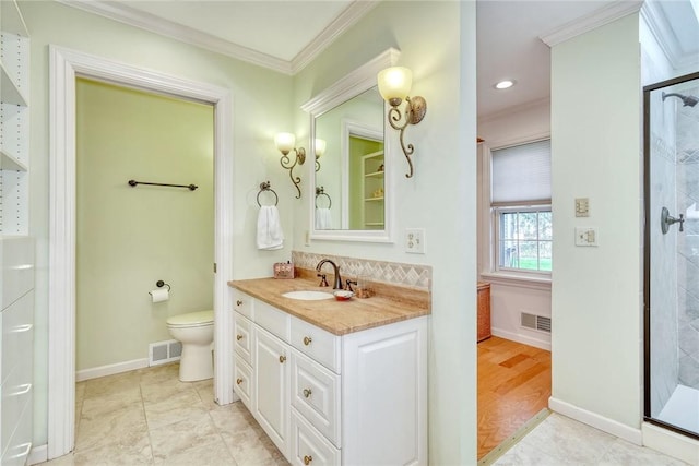 full bathroom featuring vanity, ornamental molding, a stall shower, and toilet