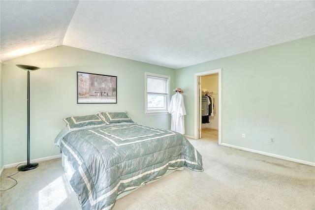 bedroom featuring carpet flooring, a textured ceiling, vaulted ceiling, and baseboards