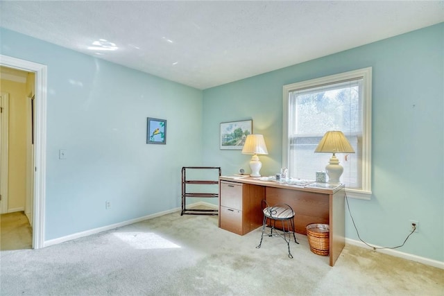 office with baseboards and light carpet