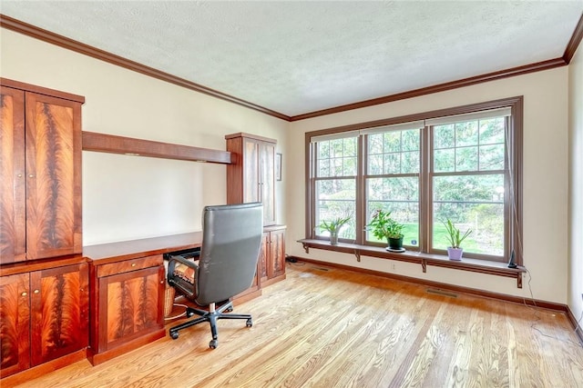 office area featuring baseboards, light wood finished floors, a textured ceiling, and a wealth of natural light
