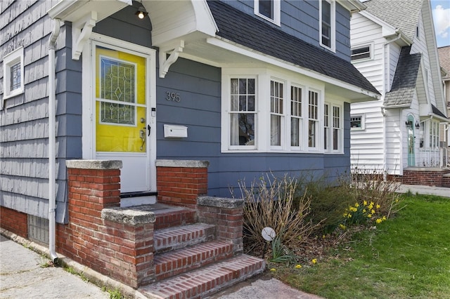 property entrance with a shingled roof