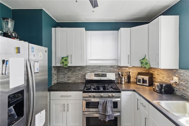 kitchen with a sink, appliances with stainless steel finishes, and white cabinets