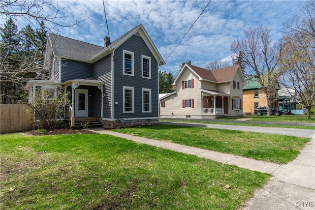 view of front of house with fence and a front yard