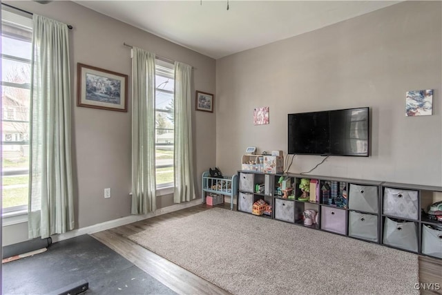 playroom with baseboards and wood finished floors