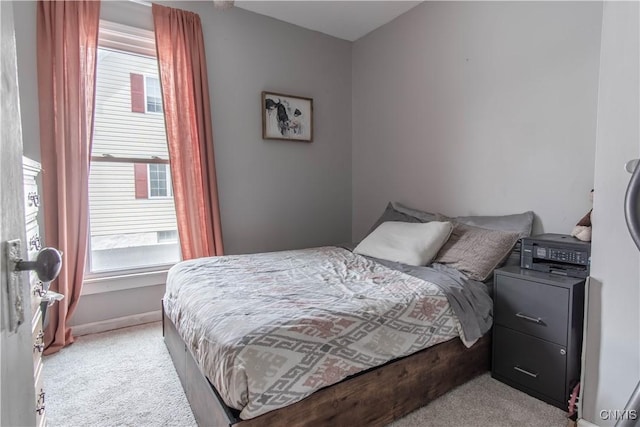 bedroom featuring light colored carpet