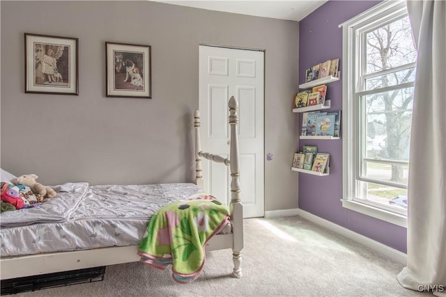 carpeted bedroom featuring baseboards