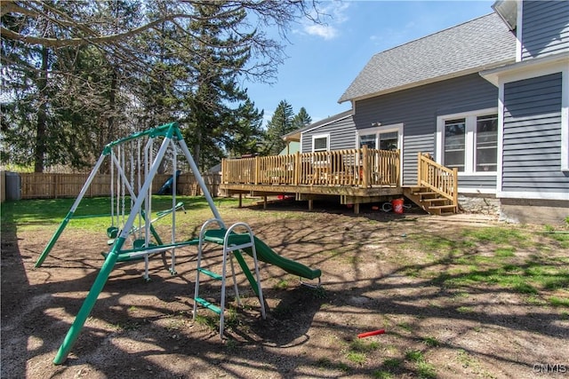 view of play area with a fenced backyard and a deck