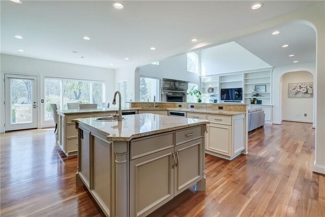 4 Windscape Park, Pittsford, NY 14534 - kitchen with a large island, arched walkways, wood finished floors, a sink, and open floor plan