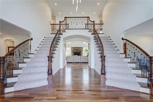 4 Windscape Park, Pittsford, NY 14534 - foyer entrance with stairway, arched walkways, wood finished floors, and a towering ceiling