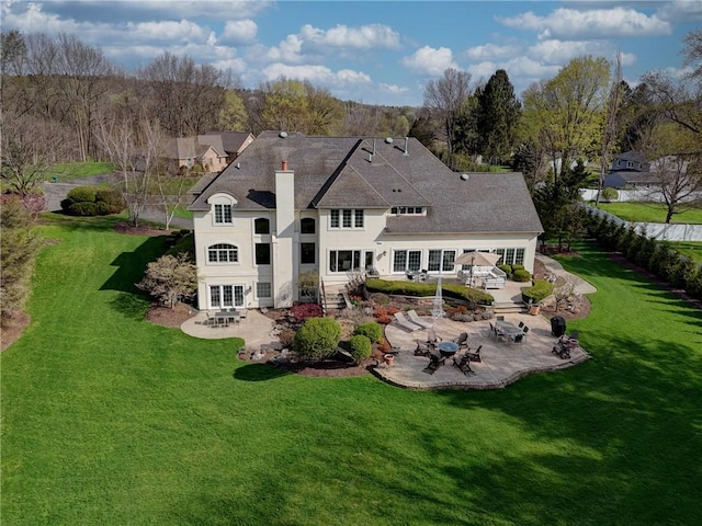 4 Windscape Park, Pittsford, NY 14534 - rear view of house with a lawn, a chimney, and a patio area
