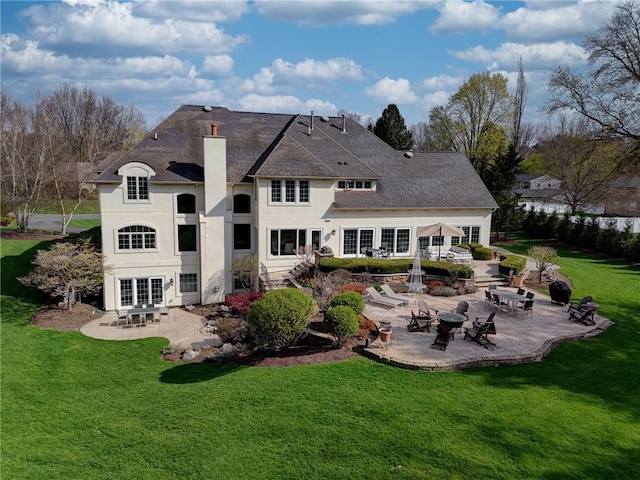 4 Windscape Park, Pittsford, NY 14534 - back of property featuring stucco siding, a yard, and a patio area