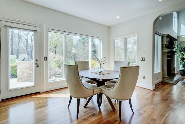 4 Windscape Park, Pittsford, NY 14534 - dining space featuring visible vents, baseboards, light wood-type flooring, recessed lighting, and arched walkways