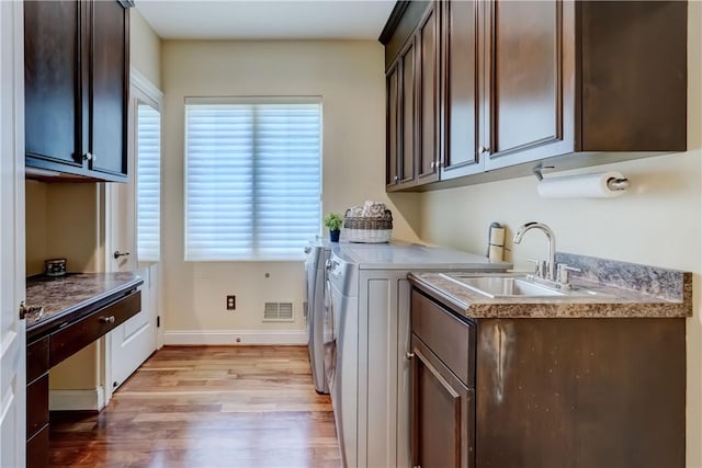 4 Windscape Park, Pittsford, NY 14534 - clothes washing area featuring cabinet space, a sink, light wood-style flooring, baseboards, and washer and clothes dryer