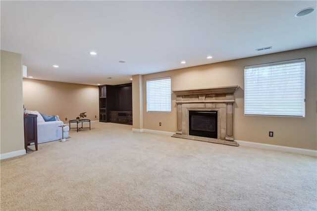 4 Windscape Park, Pittsford, NY 14534 - unfurnished living room featuring visible vents, a high end fireplace, baseboards, light carpet, and recessed lighting