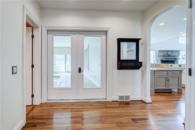 4 Windscape Park, Pittsford, NY 14534 - doorway with visible vents, arched walkways, wood finished floors, and french doors
