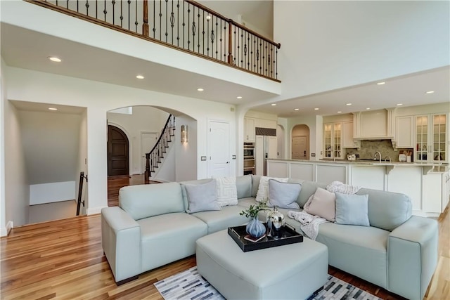 4 Windscape Park, Pittsford, NY 14534 - living area with recessed lighting, arched walkways, stairway, and light wood-type flooring