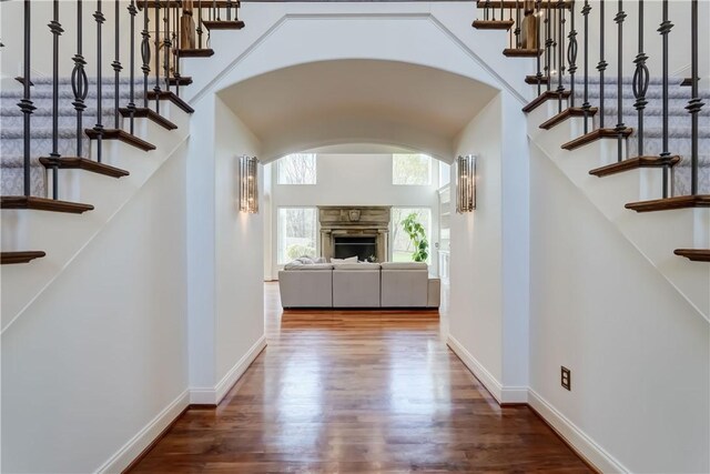 4 Windscape Park, Pittsford, NY 14534 - corridor with arched walkways, baseboards, wood finished floors, and stairway