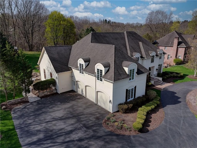 4 Windscape Park, Pittsford, NY 14534 - view of home's exterior featuring a shingled roof, stucco siding, and driveway