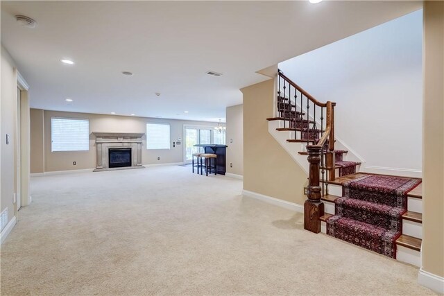 4 Windscape Park, Pittsford, NY 14534 - living area with carpet floors, a premium fireplace, a chandelier, stairs, and visible vents