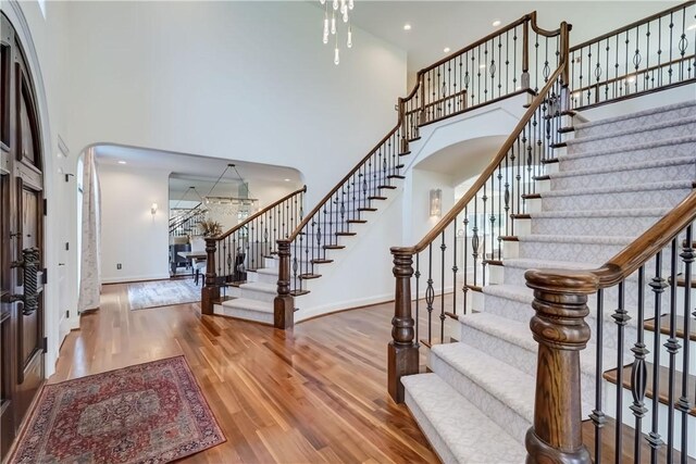 4 Windscape Park, Pittsford, NY 14534 - foyer entrance with stairs, arched walkways, wood finished floors, and a towering ceiling