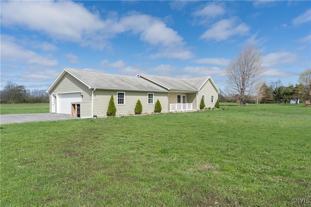 ranch-style house featuring concrete driveway, a front yard, and a garage