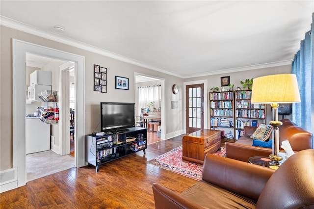 living room featuring crown molding, baseboards, and wood finished floors
