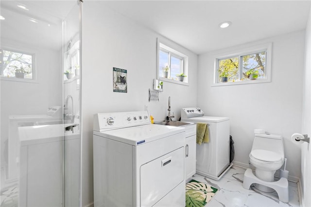 laundry room with washer and dryer, laundry area, a healthy amount of sunlight, and marble finish floor