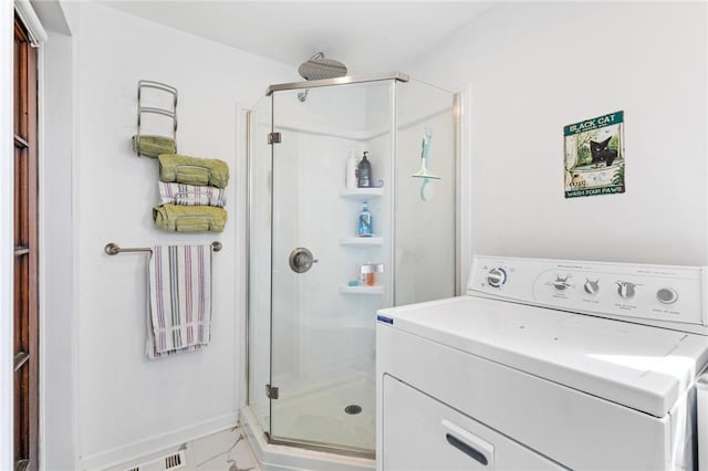 full bath with baseboards, a stall shower, washer / clothes dryer, and marble finish floor